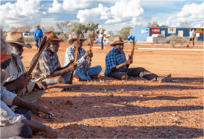 Banjo and other senior men  perform ceremonial song at the opening of Protest House.