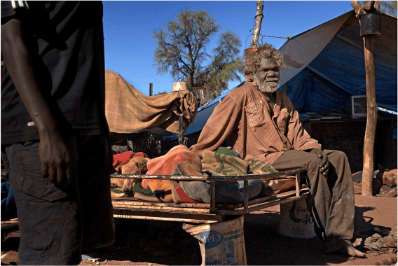 A photo of an indigenous man sitting