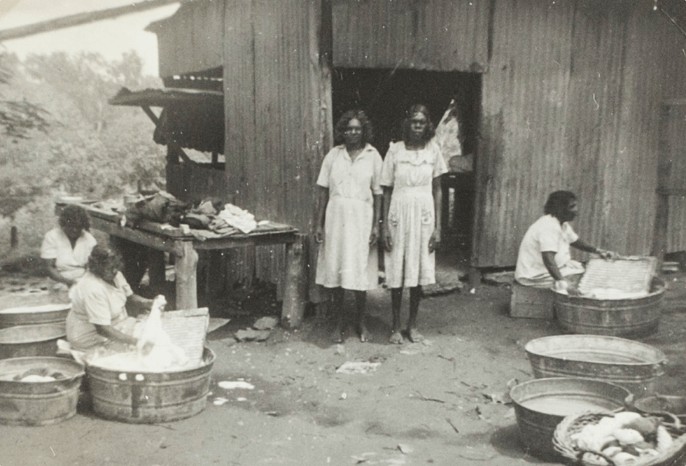 A black and white photo of Aboriginal women doing wash at Manbullo Station (N.T.)